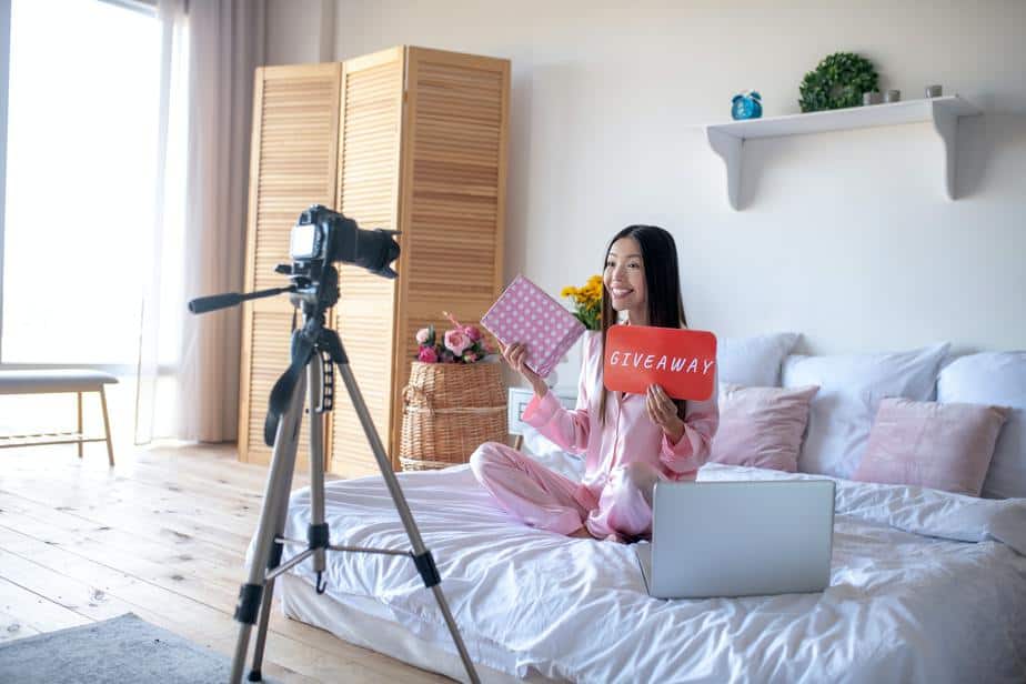 Lifestyle blogger filming giveaway in the bedroom